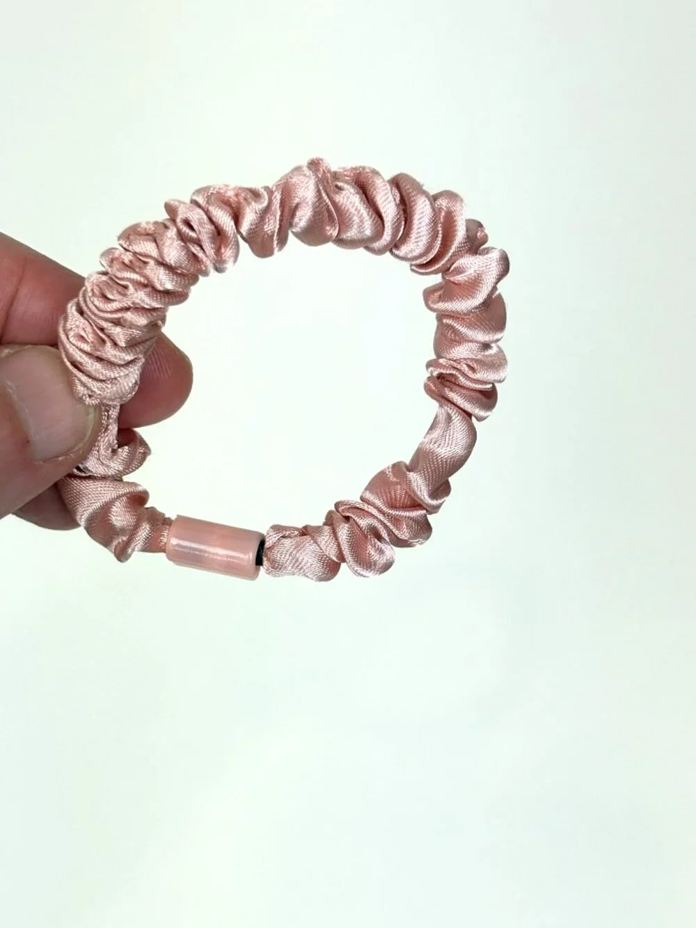 Skinny satin hair scrunchie / skinny hair tie in a light pink / blush shade. New